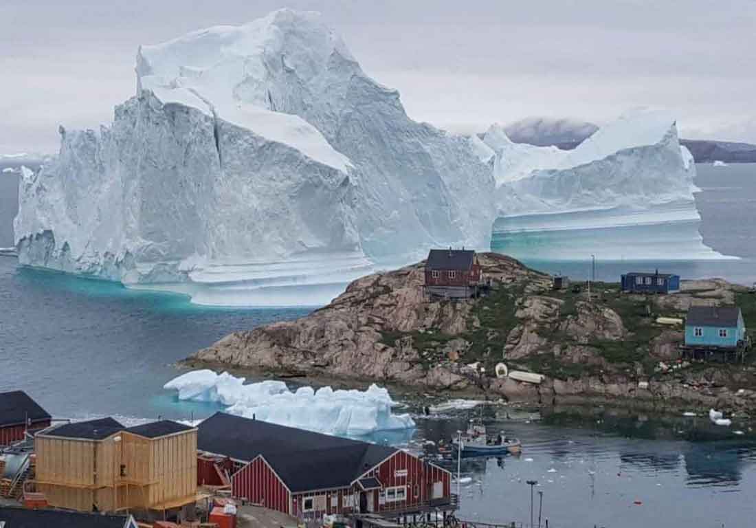A massive iceberg floats close to Innaarsuit, Greenland